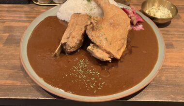 Curry with pork rib, chicken leg and garlic butter on the side at Meirindo in Tokyo