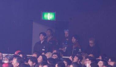 Takeshita in NJPW tracksuit watching Goto vs Zack
