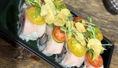 Dinnertime. Clean and delicious. Summertime roll. Yellowtail inside topped with Serrano and garlic chips.