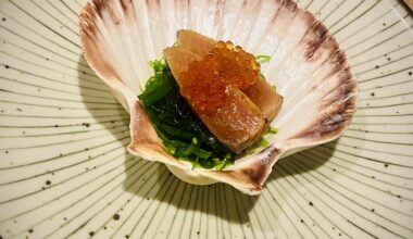 Seared salmon and ikura on a bed of seasoned seaweed