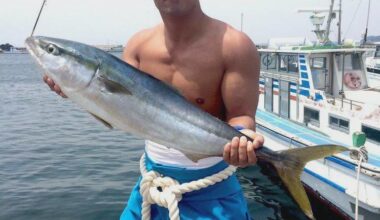 Okada showing his catch of the day in 2018