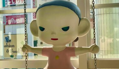 A large, suspended child-figure sculpture by artist Yoshitomo Nara. Displayed inside the Keikyu Department Store in Kamiooka, Yokohama.