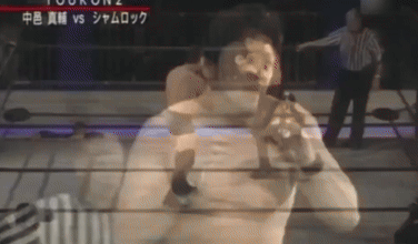 Shinsuke Nakamura takes down Ken Shamrock leading into a German Suplex