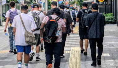 Who are these people walking in packs around Ikebukuro at 0700 in the morning, staring at their phones (sometimes multiple phones) tethered to batteries in their backpacks? Are they in other parts of Tokyo as well?